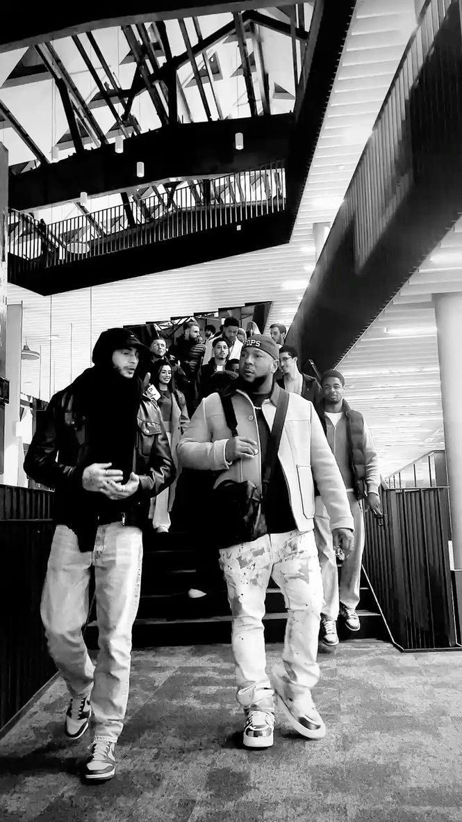 Richard Hall Jr. walking through a venue with a group behind him